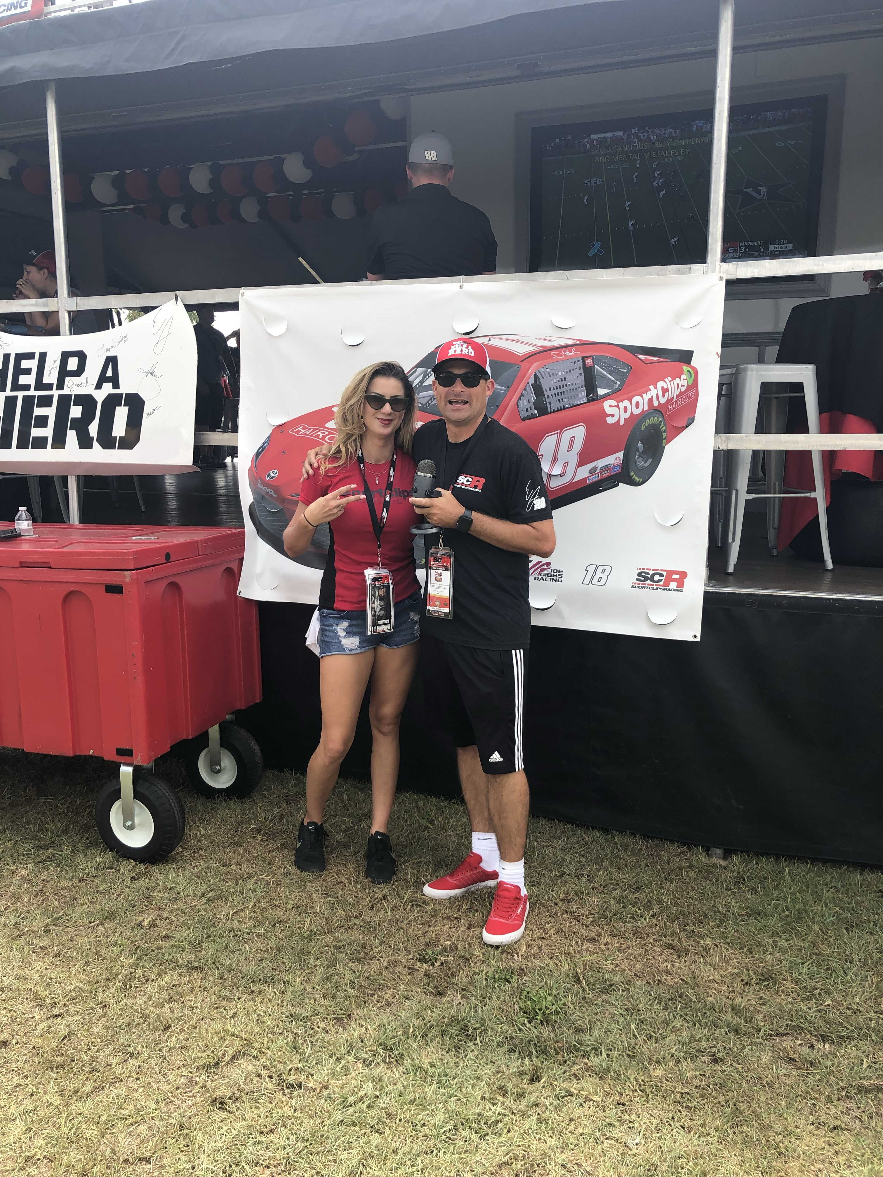 Chad Jordan and Andrea Allemand holding a microphone